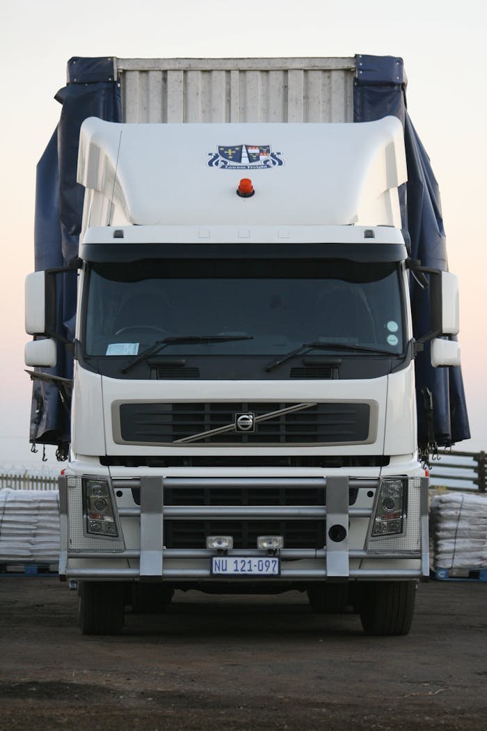 A powerful white truck captured from the front, showcasing its robust design.